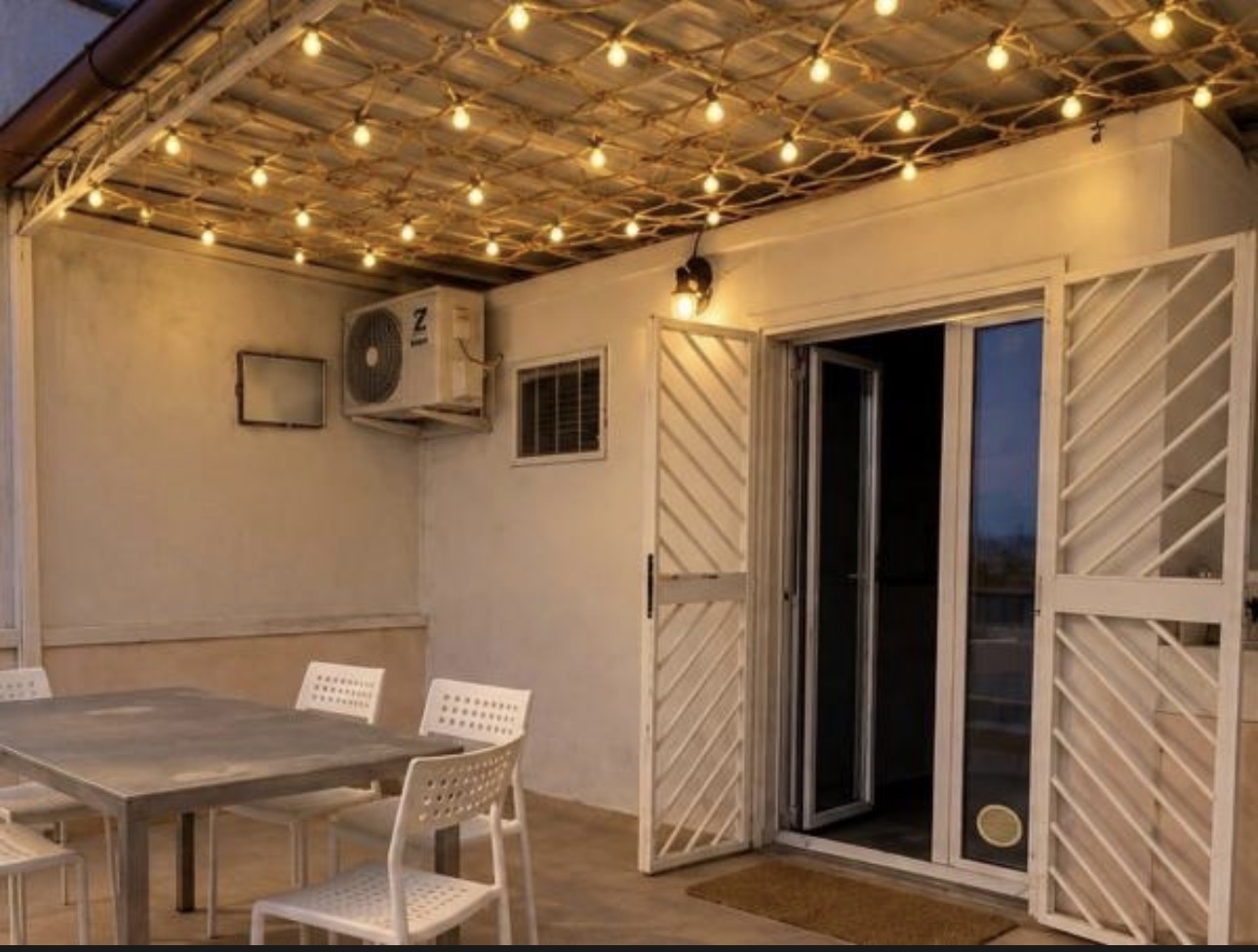 The Urban Lodge private terrace with dining table and lights
