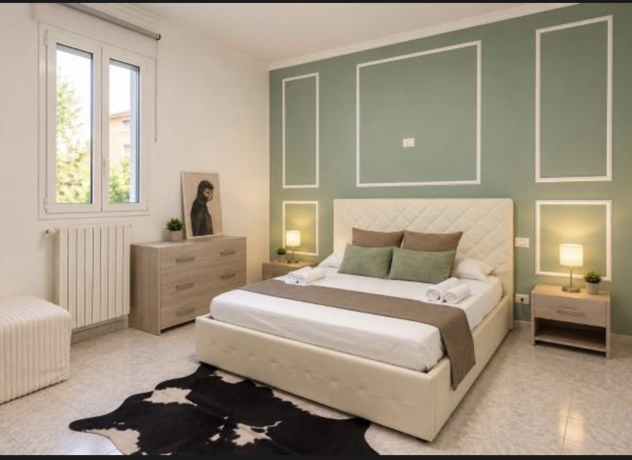 The Urban Lodge green bedroom with window and dresser
