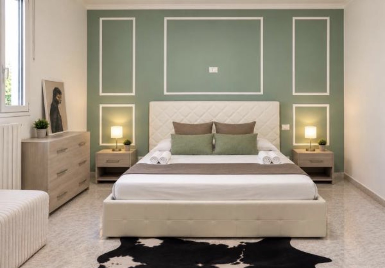 The Urban Lodge green feature-wall bedroom